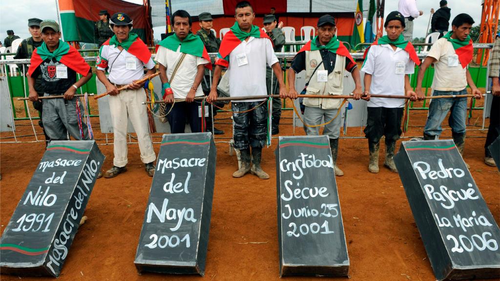 Group of men in front of symbolic coffins 