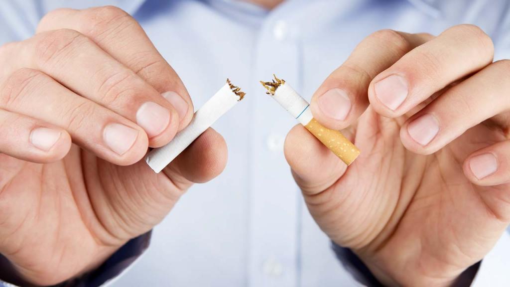 Man breaking a cigarette in half 