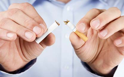 Man breaking a cigarette in half 