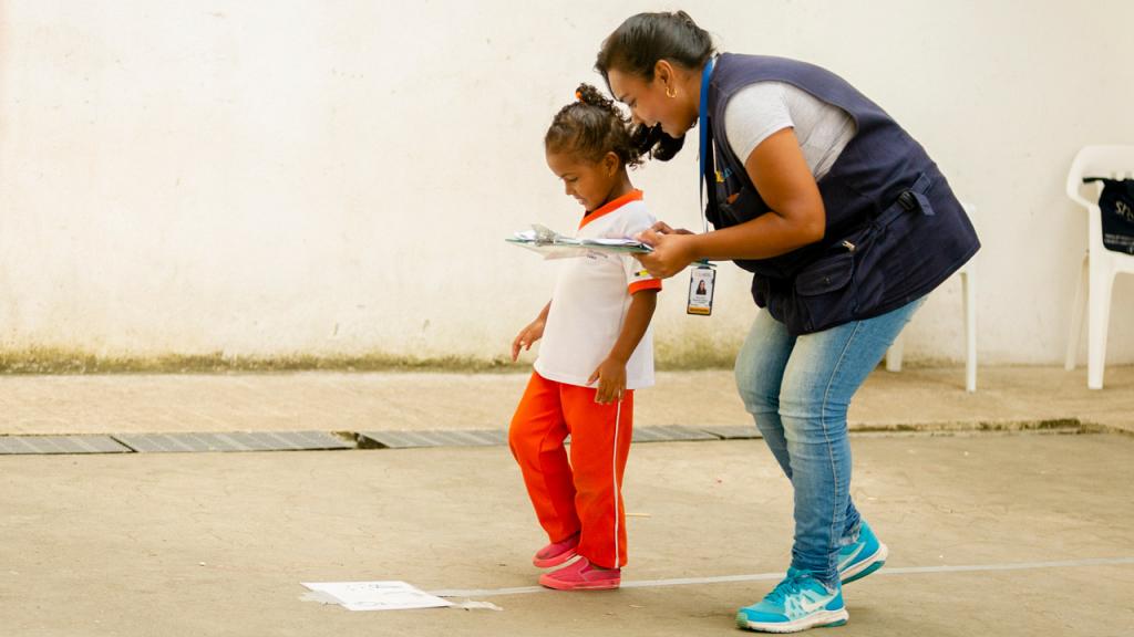 Researcher working with a little girl